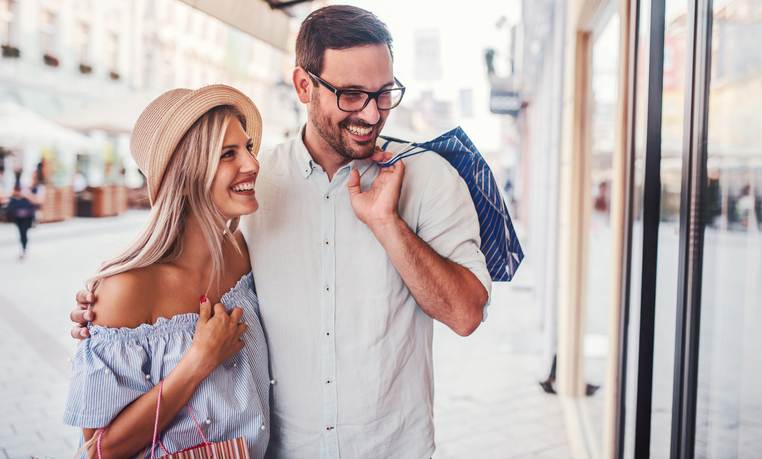 Shopping time. Young couple in shopping. Consumerism, love, dating, lifestyle concept Shopping time. Young couple in shopping. Consumerism, love, dating, lifestyle concept
