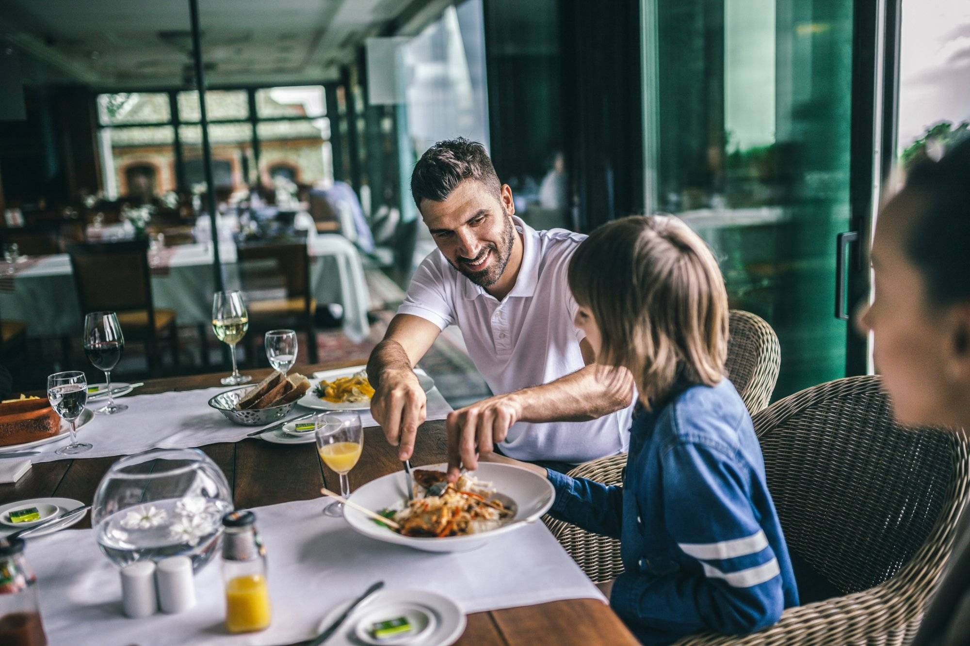 Portrait of happy family eating in the restaurant