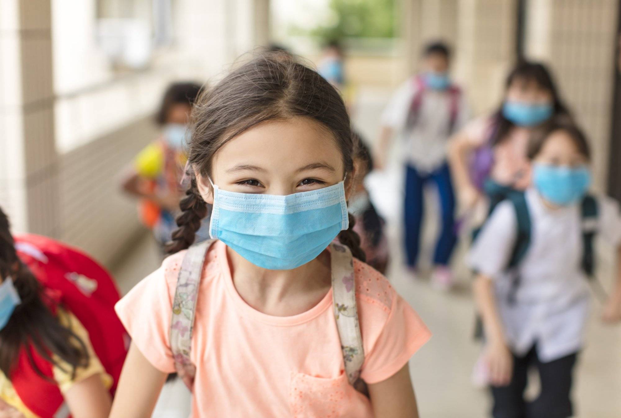 children wearing  face medical mask back to school after covid-19 quarantine